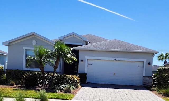 17541 Timberline Pkwy, Punta Gorda, FL 33982 - single story home with decorative driveway, an attached garage, stucco siding, and roof with shingles