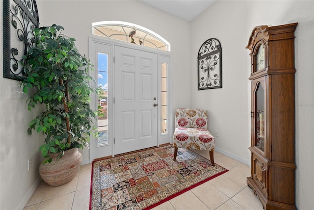 foyer featuring light tile patterned flooring and baseboards