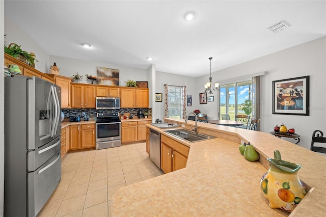 kitchen with visible vents, light tile patterned flooring, a sink, stainless steel appliances, and light countertops