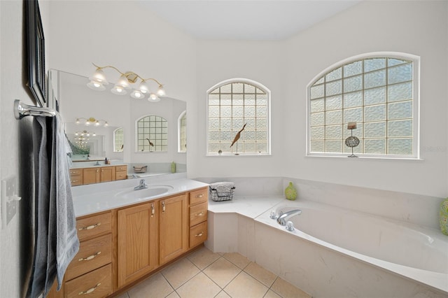 bathroom featuring tile patterned flooring, a garden tub, and vanity