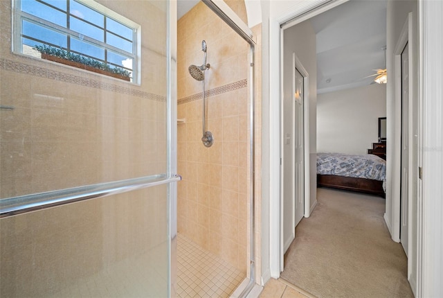 full bathroom featuring ceiling fan, ensuite bath, a stall shower, and tile patterned floors