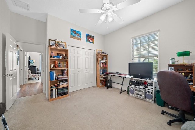 carpeted home office with a ceiling fan and visible vents