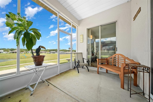 sunroom / solarium with a water view