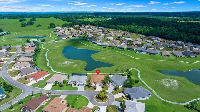 birds eye view of property with view of golf course, a residential view, and a water view