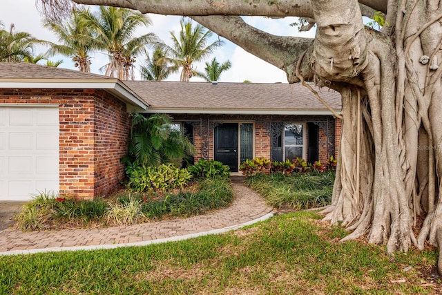 ranch-style house with a garage and brick siding