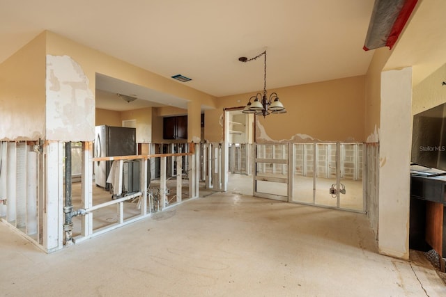 interior space featuring visible vents and an inviting chandelier