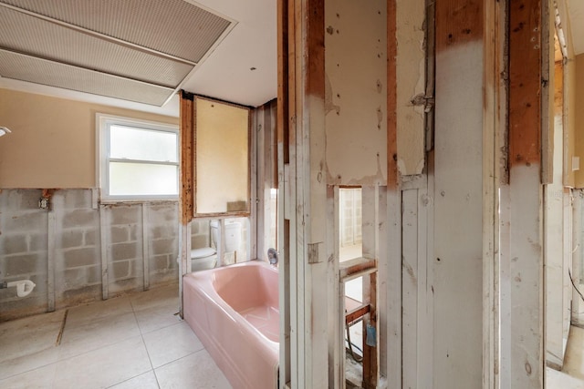 full bath with a bath, toilet, and tile patterned floors