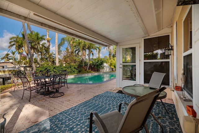view of patio / terrace with an outdoor pool and outdoor dining area