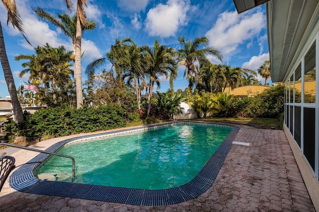 pool with a fenced backyard and a patio area