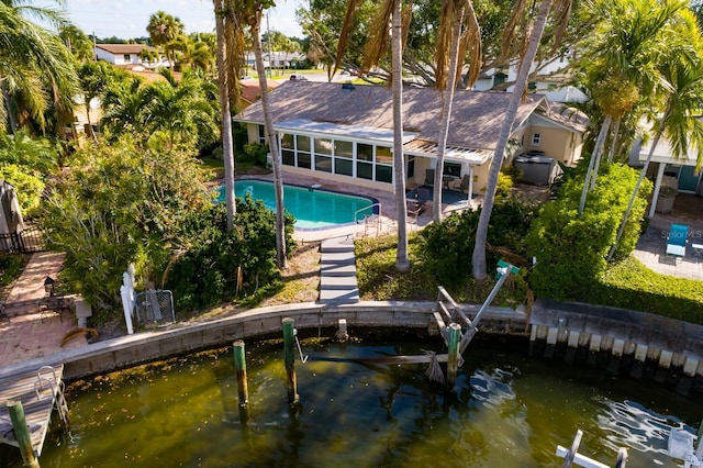 rear view of house featuring a sunroom, fence, and a patio area