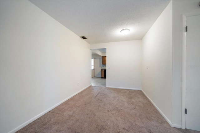 8445 Calais N, Pinellas Park, FL 33781 - spare room with light carpet, baseboards, and a textured ceiling