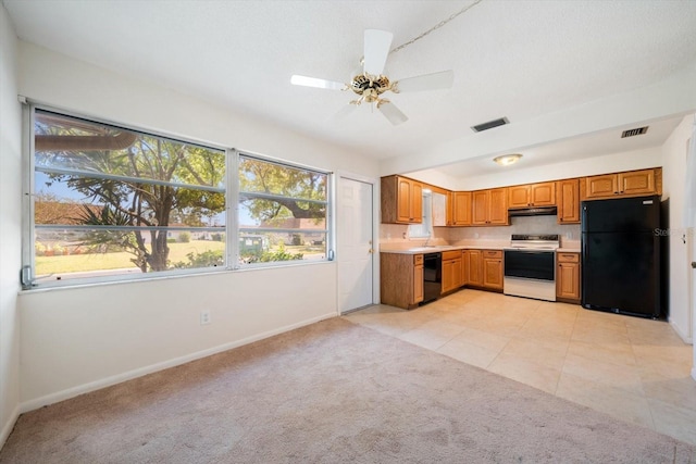 8445 Calais N, Pinellas Park, FL 33781 - kitchen with black appliances, baseboards, under cabinet range hood, and light countertops