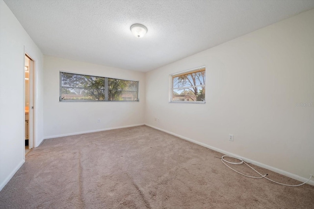 8445 Calais N, Pinellas Park, FL 33781 - carpeted spare room featuring baseboards and a textured ceiling