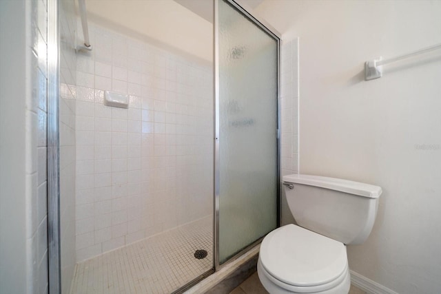 8445 Calais N, Pinellas Park, FL 33781 - bathroom featuring a stall shower, toilet, and baseboards