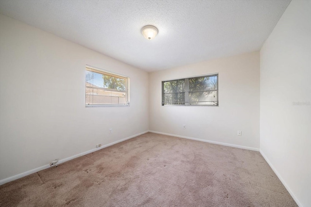8445 Calais N, Pinellas Park, FL 33781 - unfurnished room featuring carpet, baseboards, and a textured ceiling