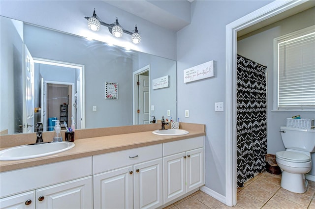 full bathroom with double vanity, a sink, toilet, and tile patterned flooring