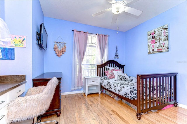 bedroom featuring hardwood / wood-style floors, ceiling fan, and baseboards