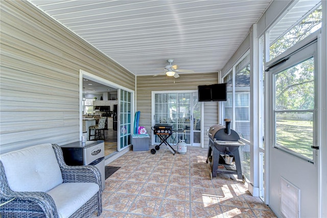 sunroom with a ceiling fan and plenty of natural light