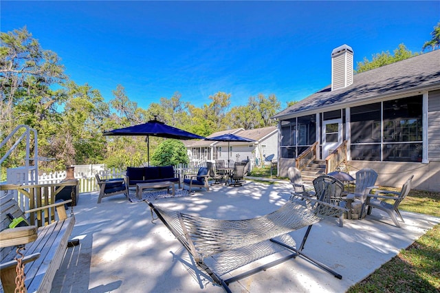 view of patio / terrace featuring outdoor lounge area, a sunroom, and outdoor dining area