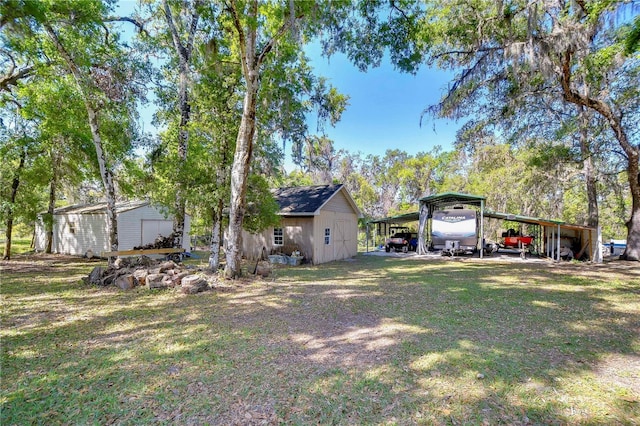 view of yard with an outbuilding and a detached carport