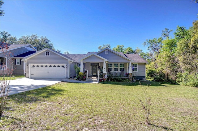 view of front of home featuring a porch, a front yard, driveway, and an attached garage