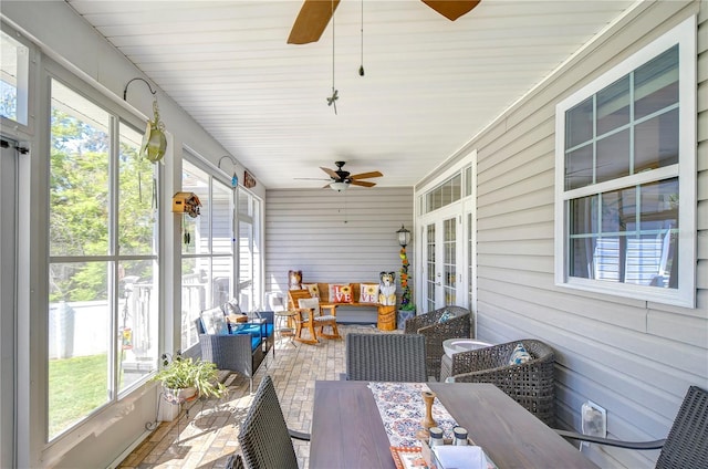 sunroom / solarium featuring an outdoor hangout area, french doors, and a ceiling fan