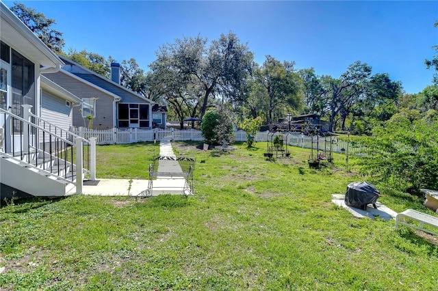 view of yard featuring a sunroom and fence