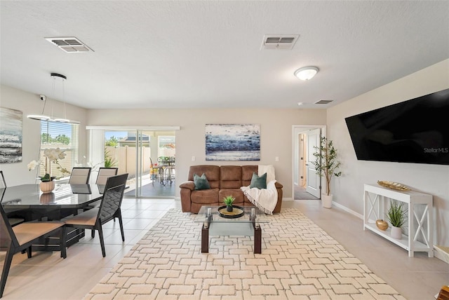 30364 Marquette Ave, Wesley Chapel, FL 33545 - living room with a textured ceiling, visible vents, and light tile patterned floors