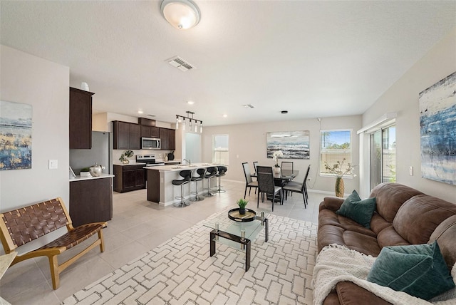 30364 Marquette Ave, Wesley Chapel, FL 33545 - living room with baseboards, visible vents, recessed lighting, and light tile patterned floors