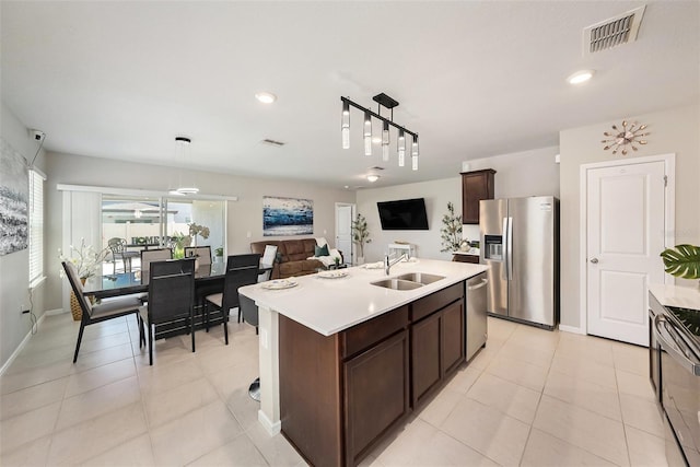 30364 Marquette Ave, Wesley Chapel, FL 33545 - kitchen with light countertops, visible vents, stainless steel appliances, dark brown cabinetry, and a sink