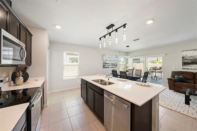 30364 Marquette Ave, Wesley Chapel, FL 33545 - kitchen featuring open floor plan, light countertops, stainless steel appliances, a sink, and visible vents