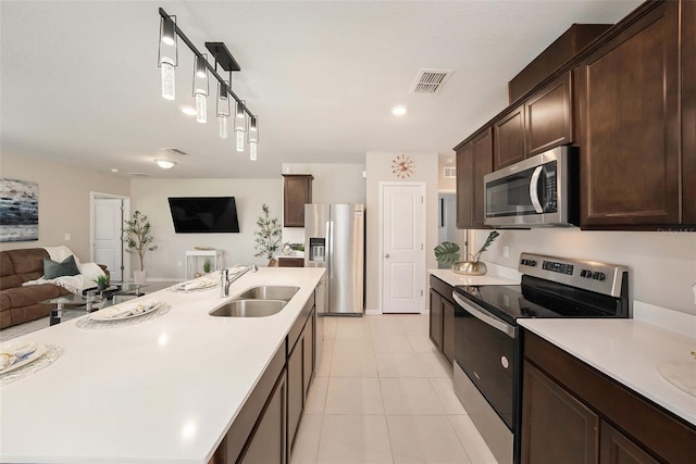 30364 Marquette Ave, Wesley Chapel, FL 33545 - kitchen with light countertops, a sink, appliances with stainless steel finishes, open floor plan, and visible vents