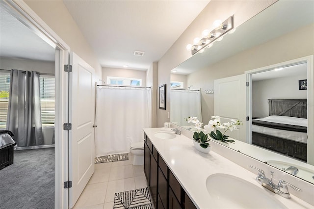30364 Marquette Ave, Wesley Chapel, FL 33545 - ensuite bathroom featuring ensuite bath, visible vents, a sink, and tile patterned flooring