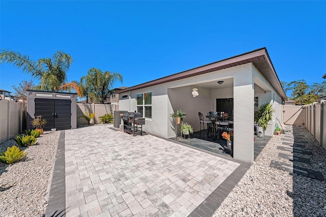 30364 Marquette Ave, Wesley Chapel, FL 33545 - view of patio / terrace featuring a fenced backyard, an outdoor structure, grilling area, and a shed