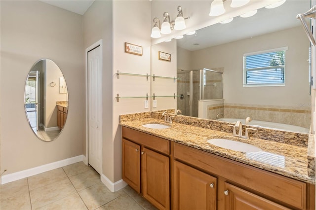 bathroom featuring a shower stall, double vanity, tile patterned flooring, a garden tub, and baseboards
