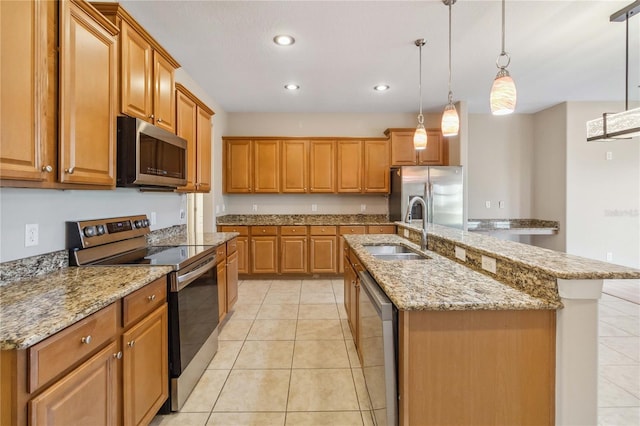 kitchen featuring appliances with stainless steel finishes, a sink, light tile patterned flooring, recessed lighting, and brown cabinetry