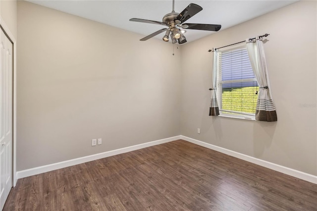empty room with baseboards, wood finished floors, and a ceiling fan