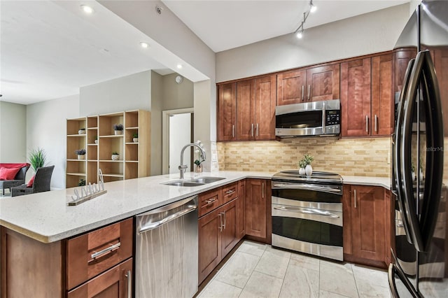 100 4th Ave S Unit 220, Saint Petersburg, FL 33701 - kitchen with appliances with stainless steel finishes, a peninsula, tasteful backsplash, light stone counters, and recessed lighting