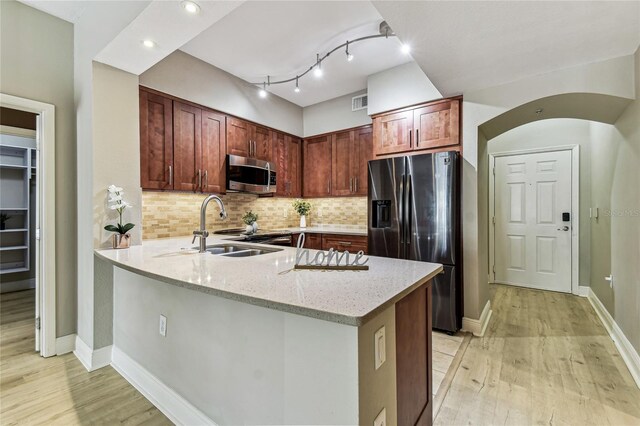 100 4th Ave S Unit 220, Saint Petersburg, FL 33701 - kitchen with appliances with stainless steel finishes, light wood-style floors, light stone countertops, and a peninsula