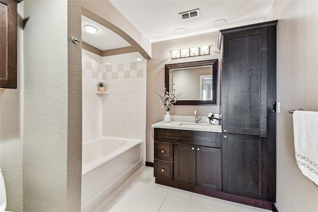 100 4th Ave S Unit 220, Saint Petersburg, FL 33701 - full bathroom with vanity, tile patterned floors, shower / washtub combination, and a textured wall
