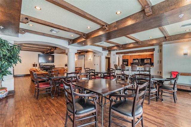 100 4th Ave S Unit 220, Saint Petersburg, FL 33701 - dining area featuring decorative columns, beam ceiling, light wood finished floors, arched walkways, and recessed lighting