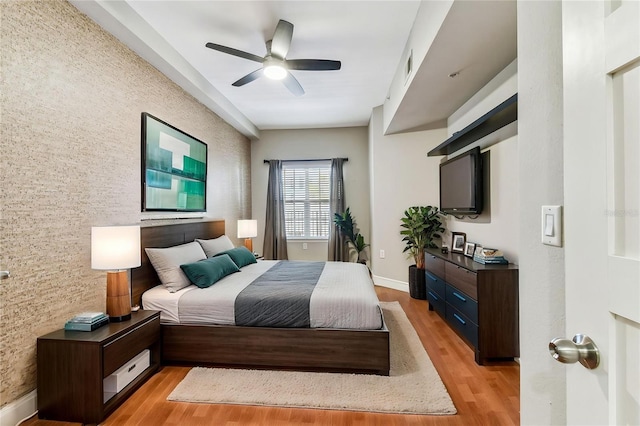 100 4th Ave S Unit 220, Saint Petersburg, FL 33701 - bedroom featuring an accent wall, light wood finished floors, and a ceiling fan