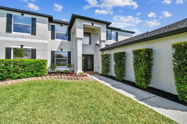 view of front of property with stucco siding and a front lawn