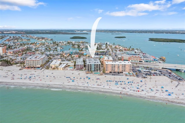 drone / aerial view featuring a water view, a view of the beach, and a view of city