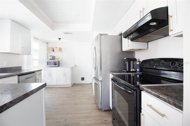 12140 74th St, Largo, FL 33773 - kitchen with under cabinet range hood, a raised ceiling, dark countertops, black range with electric cooktop, and dishwasher