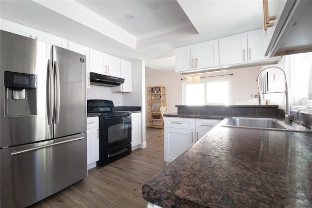 12140 74th St, Largo, FL 33773 - kitchen with stainless steel fridge, under cabinet range hood, a raised ceiling, a sink, and black range with electric stovetop