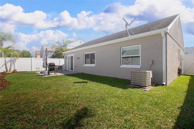 12140 74th St, Largo, FL 33773 - back of property featuring stucco siding, a patio, central AC, and a yard