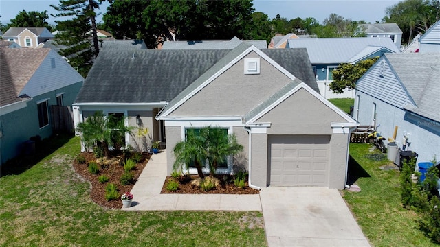 12140 74th St, Largo, FL 33773 - view of front of property with an attached garage, concrete driveway, a front yard, a residential view, and stucco siding