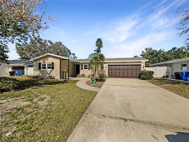 ranch-style home with stucco siding, driveway, fence, a front yard, and a garage