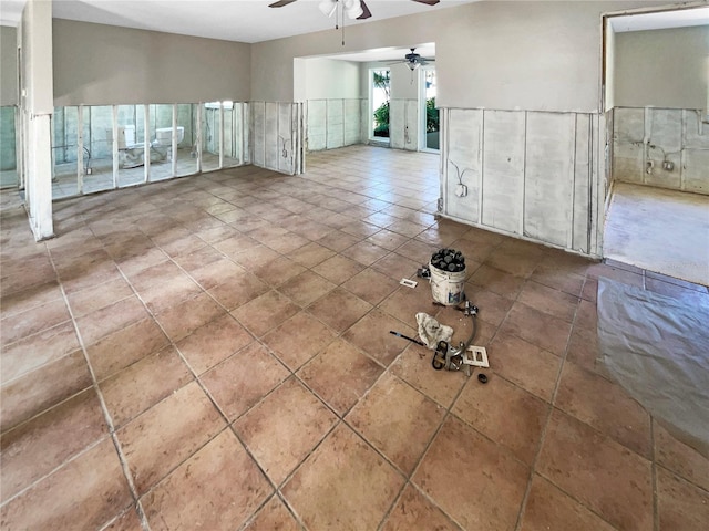 tiled spare room with ceiling fan